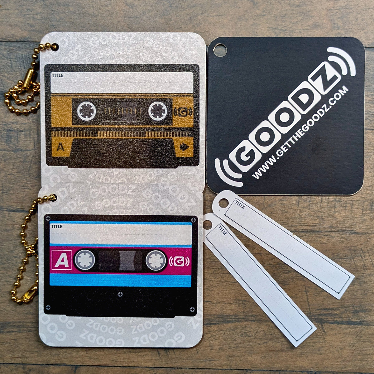 Black & Gold and Pink & Blue Mixtape Goodz with blank title stickers and a Goodz card
