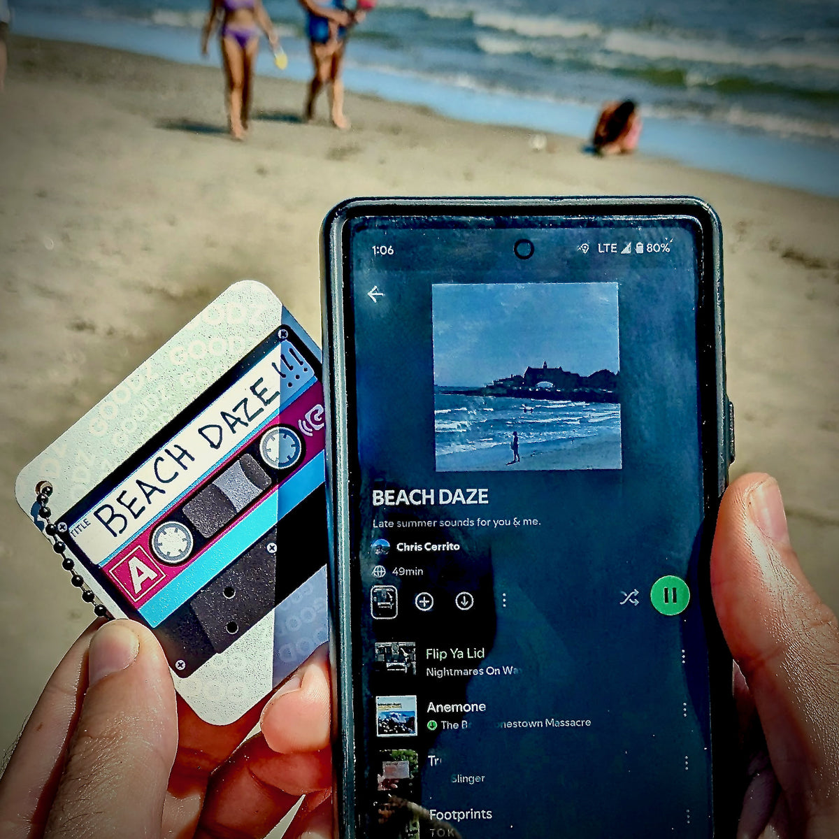Mixtape Goodz labeled Beach Daze held at the beach beside a phone playing the playlist