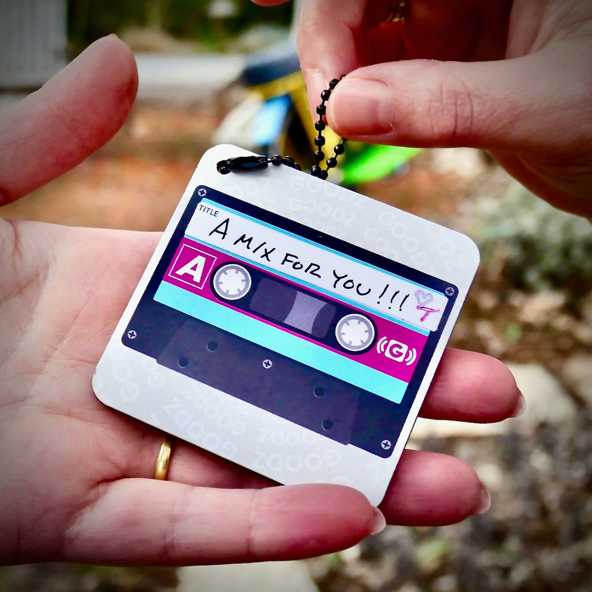 A Mixtape Goodz labeled A Mix for You being handed over as a gift
